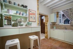 a kitchen with a counter and two stools at A33 Rhodes Old Town House in Rhodes Town