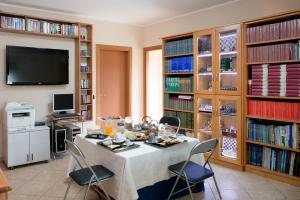 a dining room with a table and chairs and book shelves at Mastro Gio in San Giovanni in Fiore