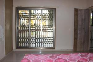 a room with a door with a gate and a rug at Ladakh House- 3 BHK Ladakh themed Villa near Matheran in Neral