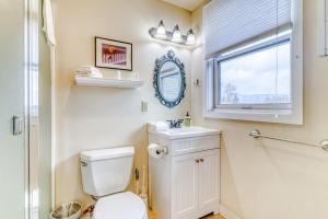 a bathroom with a toilet and a sink and a window at Azusa House in Hood River +41 photos