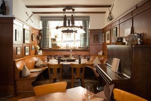 a restaurant with a table and chairs and a window at Brutsches Rebstock in Laufenburg