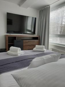 Posteľ alebo postele v izbe v ubytovaní Apartmány Urban