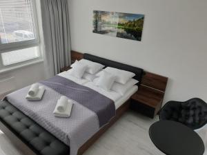 Posteľ alebo postele v izbe v ubytovaní Apartmány Urban