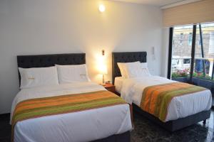 Postel nebo postele na pokoji v ubytování Samalá Casa Hotel
