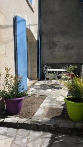 a patio with a table and chairs next to a building at maison troglodyte in Pocé-sur-Cisse