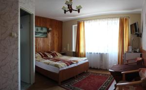 a bedroom with a bed and a large window at DW FALA in Rewal