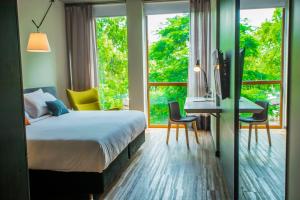 A bed or beds in a room at Five Hotel & Residences
