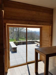 a sliding glass door in a room with a patio at Chambre d'hôtes aux Pays des Sucs in Saint-Hostien