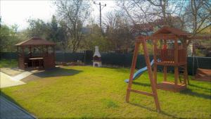 a playground with a slide and a gazebo at Willa Sokołówka in Polanica-Zdrój