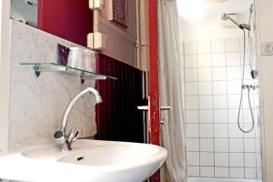 a bathroom with a white sink and a shower at De Mallemoolen in Amsterdam +18 photos