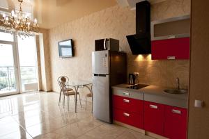 a kitchen with a refrigerator and a table in it at MOST City 2-Room Apartment with Balcony in Dnipro