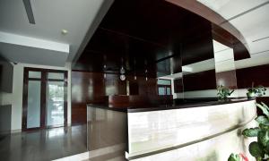 a kitchen with dark wood cabinets and a counter at MOST City 2-Room Apartment with Balcony in Dnipro +3 photos