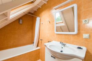 a bathroom with a sink and a mirror at Casa Dos Barcos Furnas in Furnas