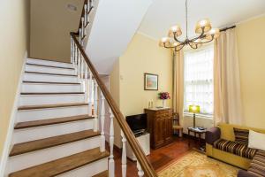 a stairway in a living room with a couch at Casa Dos Barcos Furnas in Furnas