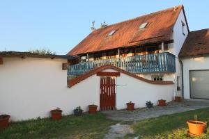 ein weißes Haus mit einem Balkon an der Seite in der Unterkunft Gästehaus Roensch in Frensdorf