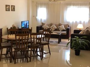 a living room with a table and chairs and a couch at El-Shorouk Housing gate2 in Cairo