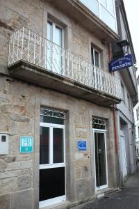 a balcony on the side of a building at Pension Pardellas in Palas de Rei