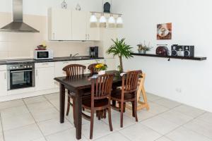 a kitchen with a wooden table and chairs at Ferienhof Kolauerhof - Bauernhofurlaub in Grömitz in Grömitz