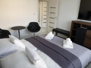Posteľ alebo postele v izbe v ubytovaní Apartmány Urban