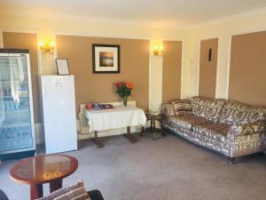 a living room with a couch and a table at Seawold Guest House in St Brelade