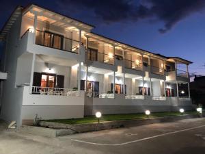 a white building with lights in front of it at Filoxenia Studios in Afitos