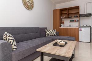 a living room with a couch and a wooden table at Sergios Apartments 13 in Alexandroupoli