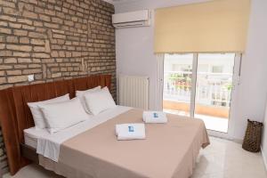 a bedroom with a bed with two towels on it at Sergios Apartments 13 in Alexandroupoli