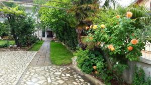a garden with flowers and a walk way at Apartments & Rooms Tom in Medulin