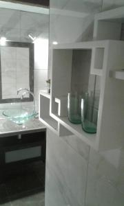 a bathroom with a glass sink and a mirror at House Kapetan Nono in Drače