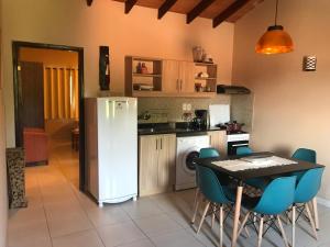a kitchen with a table and a white refrigerator at Mandala in Luque