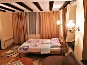 a small bedroom with a bed and a table at St. Varvara Apartments in Ohrid