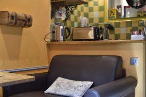 a black chair sitting under a counter in a restaurant at La Coloniale in Saint Malo