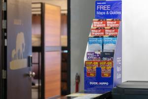 a stack of free mixes and crisps on a counter at 7 Wonders Hostel at Upper Dickson in Singapore