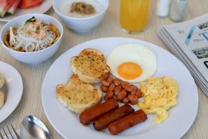 a white plate topped with different types of food at Citadines Uplands Kuching in Kuching