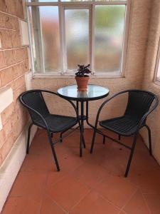a table and two chairs sitting next to a window at Olive's Cottage in Mount Gambier