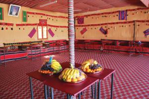 three bowls of fruit on tables in a classroom at Bidiya Desert Camp in Badīyah