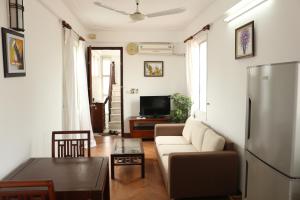 a living room with a couch and a table at Davidduc 224 Âu Cơ in Hanoi