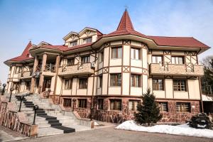 a large building with a red roof at Alpen Ville in Almaty