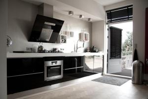 a black and white kitchen with a stove and a sink at Paradise suite in Veere