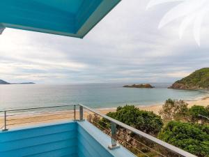 a view of the beach from the balcony of a house at Cair Paravel at Seal Rocks in Seal Rocks