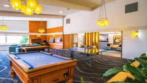 a living room filled with furniture and a pool at Heartland Hotel Haast in Haast