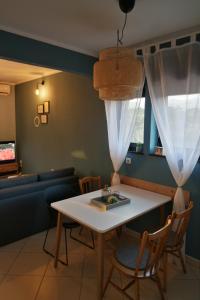 a living room with a table and chairs and a couch at Apartment Ivana in Novi Vinodolski