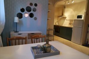 a kitchen with a table with chairs and a refrigerator at Apartment Ivana in Novi Vinodolski