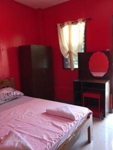 Postel nebo postele na pokoji v ubytování Panglao Rainbow Inn