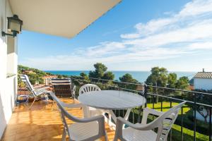 balcón con mesa, sillas y vistas al océano en K-2 CALELLA DE PALAFRUGELL, 4 PaX, en Calella de Palafrugell