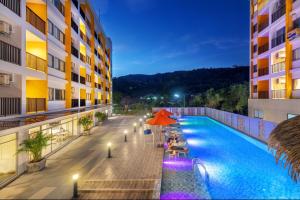 a view of a hotel swimming pool at night at Beehive Boutique Hotel Phuket in Phuket