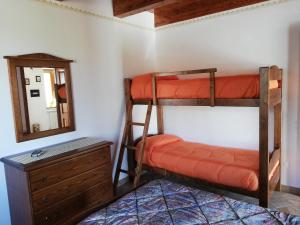 a bedroom with two bunk beds and a mirror at Azienda Agrituristica La Casetta del Pollino in Mormanno