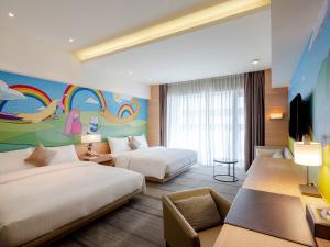 Ένα ή περισσότερα κρεβάτια σε δωμάτιο στο Hotel COZZI Ximen Tainan