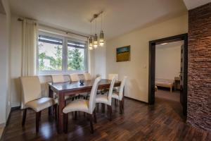 a dining room with a table and chairs at Classy Apartment - Ski Telgart in Telgárt