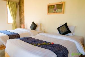 A bed or beds in a room at Sapa Eco Bungalows & Spa
